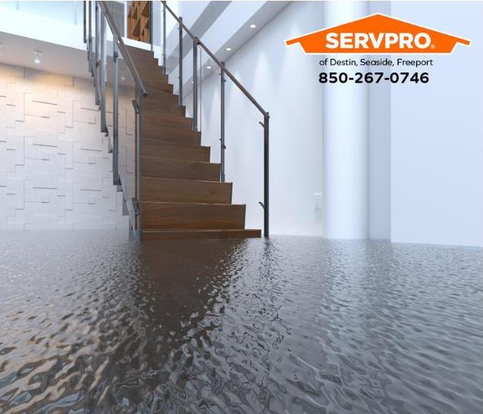 Stairs lead to a flooded floor in a commercial building.